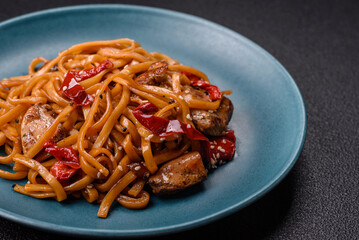 Delicious Asian food udon with noodles, chicken, hot pepper, vegetables