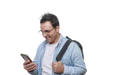 Man with glasses smiles while checking phone in casual outfit with backpack in a bright indoor setting