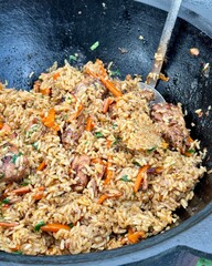 Cooking pilaf in a cauldron in the country. High quality photo