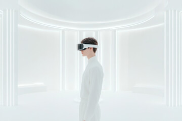Individual wearing virtual reality headset in futuristic white room with glowing light accents during a technology demonstration