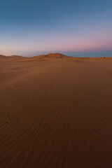 Sand Dune at Sunrise with Vibrant Orange and Red Hues