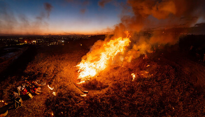 Fire brings renewal and destruction to landscape at sunset