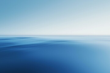 Obraz premium A smooth, serene blue abstract background, where soft gradients blend seamlessly to create a peaceful and calming atmosphere.