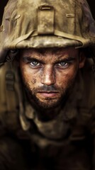 A soldier stares intensely into the camera, revealing a face marked by dirt and sweat. His expression conveys the weight of duty and the challenges faced in combat.