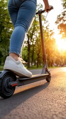 Obraz premium A person gracefully riding an electric scooter along a winding park path at sunset, enveloped by trees bathed in warm, golden light