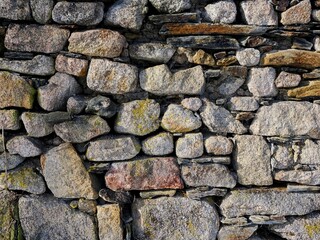 Old stone wall, mainly made of granite boulders. High resolution photos.