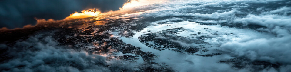 Fototapeta premium Aerial View of Coastal Landscape with Cloud Cover at Sunset