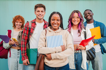 Joyful Group of Multicultural Teenage Students Standing Side by Side with Books and Notebooks,...