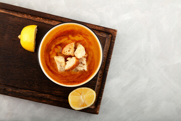 Turkish Red Lentil Soup (Kırmızı Mercimek Çorbası) with vegetables, mint, pepper, and lemon juice. Traditional delicious Turkish food, morning soup