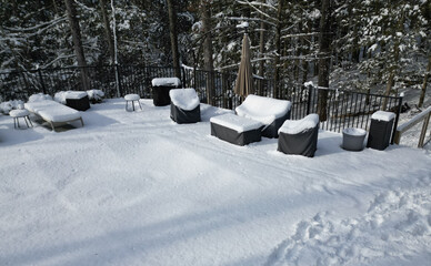 outdoor furniture in back yard covered in snow (poolside patio couch chair coffee table) chairs...