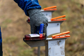 A woman punching at the orienteering control point