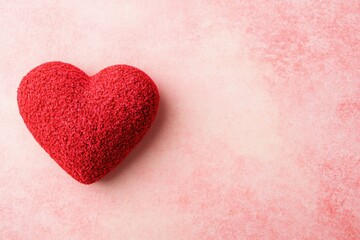 Obraz premium Charming Red Heart on Soft Pink Background