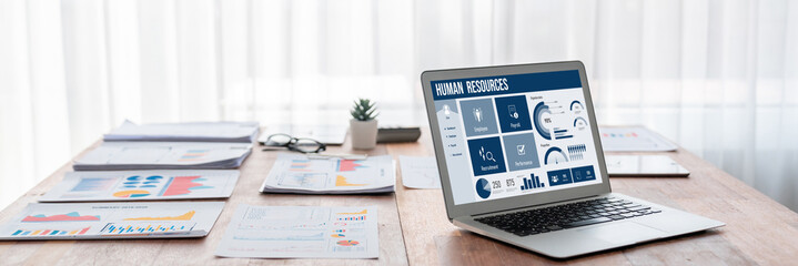 Human resources management software on computer screen helping human resources employee to manage recruitment, payroll, staff searching and KPI evaluation brisk