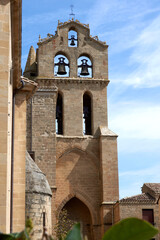Fachada frontal de iglesia con cielo azul. Se distingue el campanario.