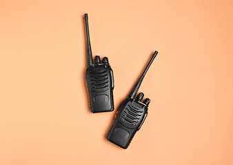 Walkie talkies on beige background, top view