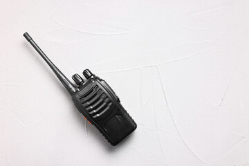 One walkie talkie on white table, top view. Space for text
