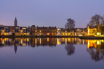 Village of Halfweg, Province North Holland, The Netherlands, residential neighbourhood in the evening mirrored in the canal