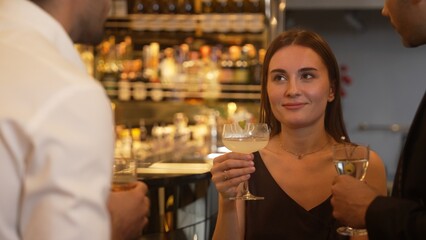 Focusing beautiful woman lively talking with friends while enjoy drinking Margarita cocktail at luxurious counter bar nightclub creating vibrant engaging atmosphere on Friday night meeting. Vinosity.
