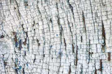 Old cracked paintwork on a wooden block