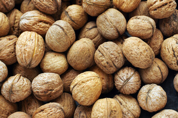 Top view of whole walnuts as background texture