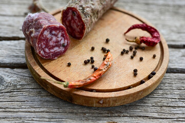 Air-dried typical  Italian salami from Tuscany served on a wooden board .  Autentic Tuscan Salami from San Gimignano, Siena 