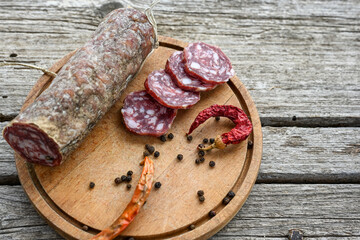 Air-dried typical  Italian salami from Tuscany served on a wooden board .  Autentic Tuscan Salami from San Gimignano, Siena 