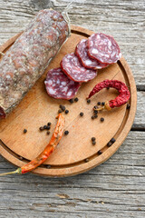Air-dried typical  Italian salami from Tuscany served on a wooden board .  Autentic Tuscan Salami from San Gimignano, Siena 