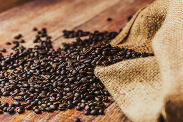 coffee beans in a burlap on a wooden background