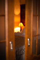 a beautiful photo of a bedside lamp in a hotel room