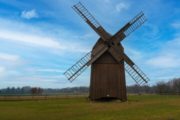 A historic wooden windmill from the 19th century, a testament to ancient wind power technologies. Made from pure wood, it highlights eco-friendly practices in early energy generation.