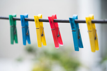 different colors of clothespins for washed clothes on a string