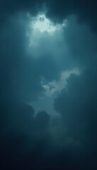 Softly filtered sunlight peeks through a dark and dense storm cloud formation, stormy, scenery