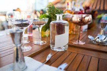 many different ingredients on the bartender's table for making alcoholic cocktails