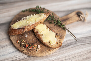 Fototapeta premium breakfast of sandwich with butter on a wooden board
