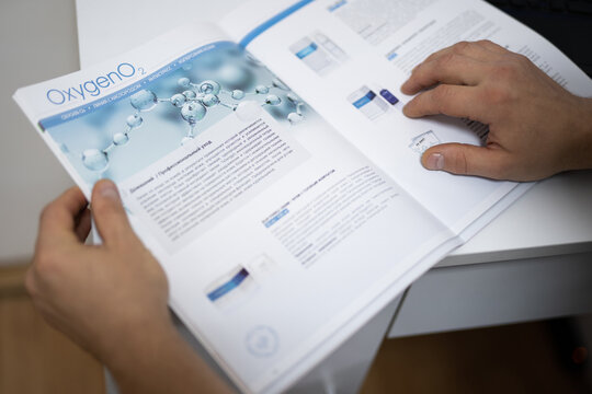 a beautician reads scientific literature in his office