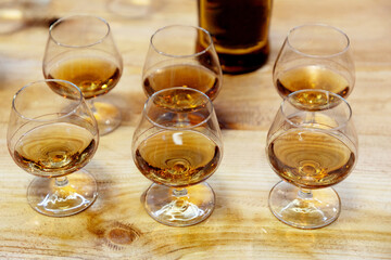 many glasses with strong alcohol stand on the table ready to drink