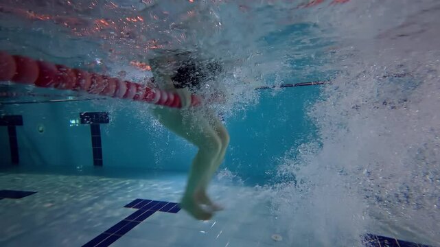 a young woman practicing flips in a swimming pool.