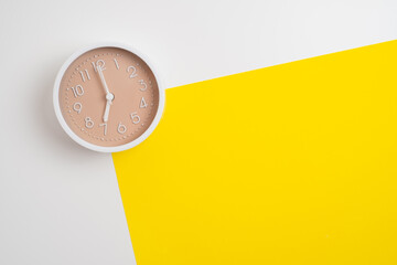 White alarm clock on a colored background. Fashionable minimalist style. Time, business and...