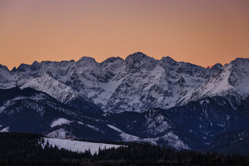 Winter sunrise on the meadow under the Tatra Mountains. Poland