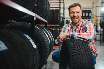 Man chooses winter car tires in the auto shop