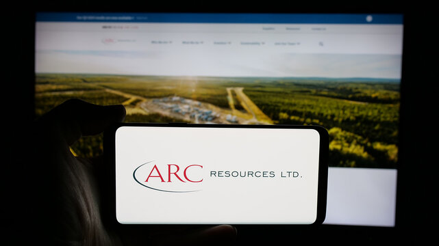 Stuttgart, Germany - 01-20-2025: Person holding cellphone with logo of Canadian oil and gas company ARC Resources Ltd. on screen in front of webpage. Focus on phone display.