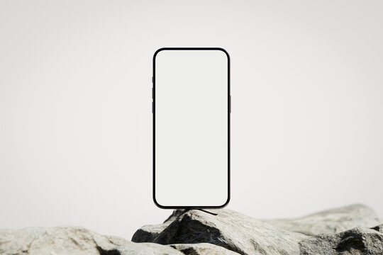 Phone with the blank white screen on the rock