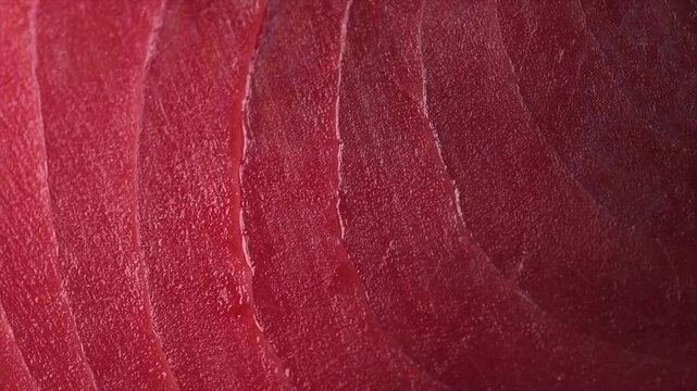 Tuna texture background, steak. Fresh raw tuna fish fillet close-up, sea fish rotating backdrop, top view, flat lay. Fresh sliced bluefin tuna raw meat texture macro shot