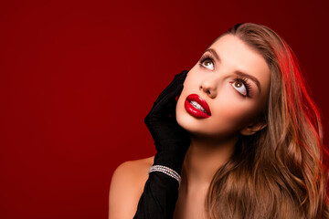 Fototapeta premium Photo of classy gorgeous lady touch black gloves face having bright make up look up empty space red color background