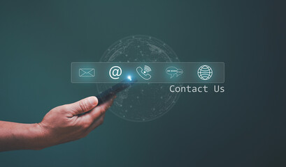 Contact us or hotline customer information support connect, Businessman using mobile phone and touching on virtual screen contact icons (www, email, address, live chat, internet phone).