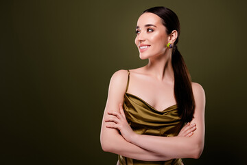 Photo of stunning happy lady crossed arms looking banner empty space on khaki color background