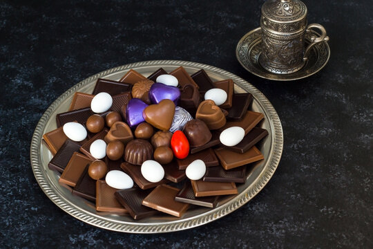 Traditional Turkish Chocolates designed on metal plate with colorful candies and coffee