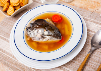 Portion of soup made of salmon offal served on table.