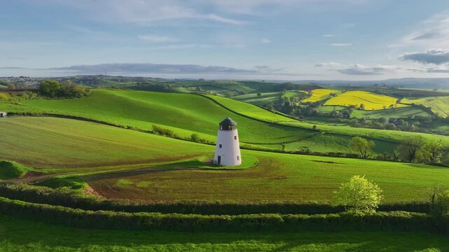 Windmill over fields and farms from a drone, Torquay, Devon, England
