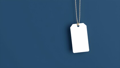 white blank tag, hanging price tag, dark blue background, minimalist, product label, simplicity, clean design, retail, merchandising, empty space, contrast